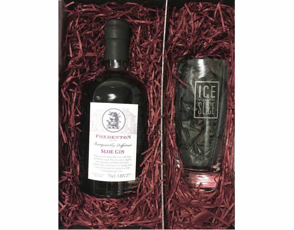 70cl of bottle Foxdenton Sloe Gin in a gift box with an Ice and a Slice Branded Hiball glass, surrounded by burgundy shredded paper in a black magnetic gift box